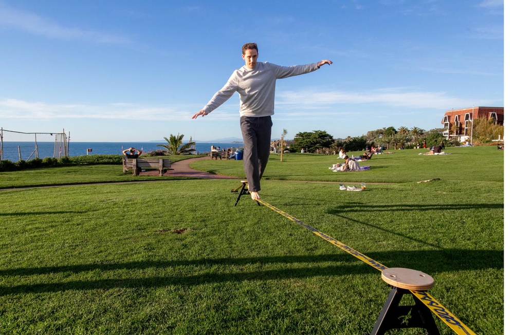 Man balancing near the ocean on a SlackYard